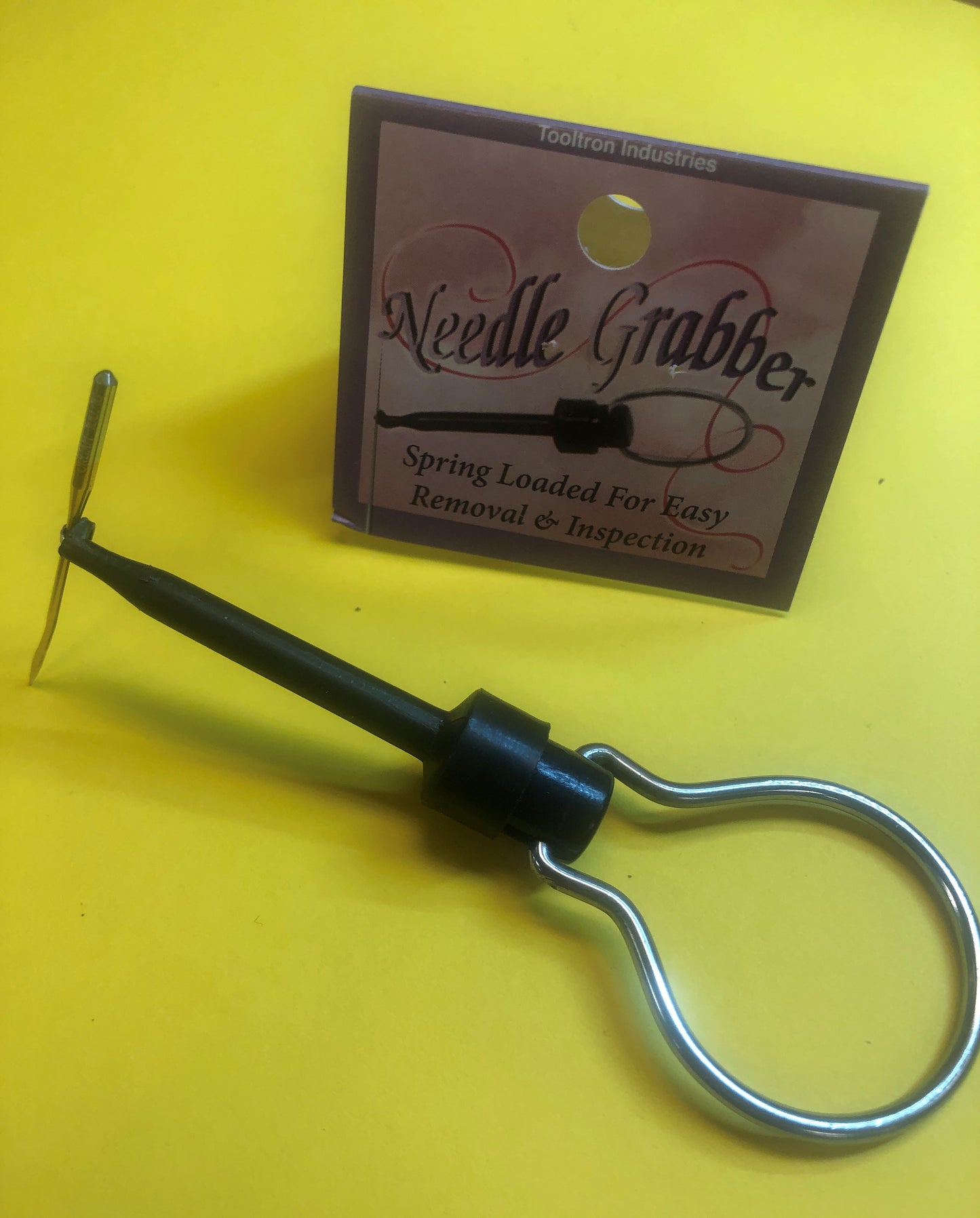 Needle Grabber with handle. Spring loaded hook to hold sewing machine needle to insert in machine