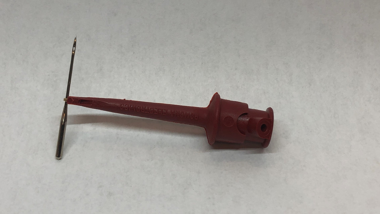 Needle Grabber holds needle to insert in sewing machine